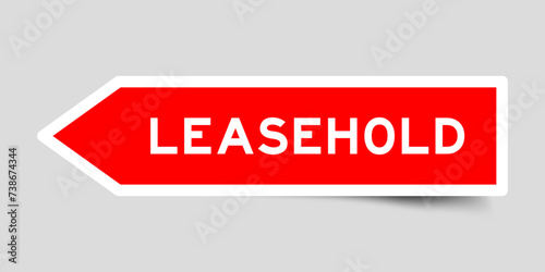 Red color arrow shape sticker label with word leasehold on gray background