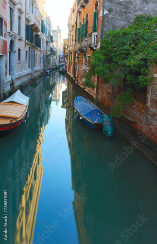 glimpse of a navigable canal on the island of Venice with boats