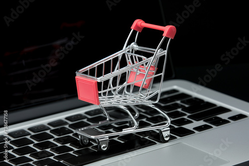 Mini trolley cart on a laptop keyboard for e-commerce and Online Shopping Concept,