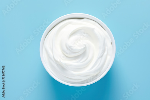 Creamy Delights: Wholesome White Yogurt, a Fresh and Natural Dairy Product, on a Hygienic Blue Background