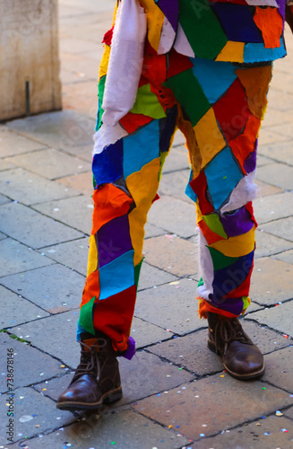 legs of the man disguised as Harlequin the Italian mask during the Carnival