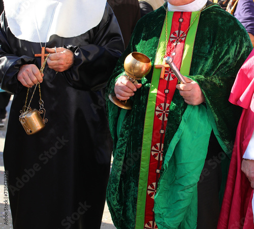 Obraz na plátně priest with cassock and aspergillum with holy water and incense during the holy