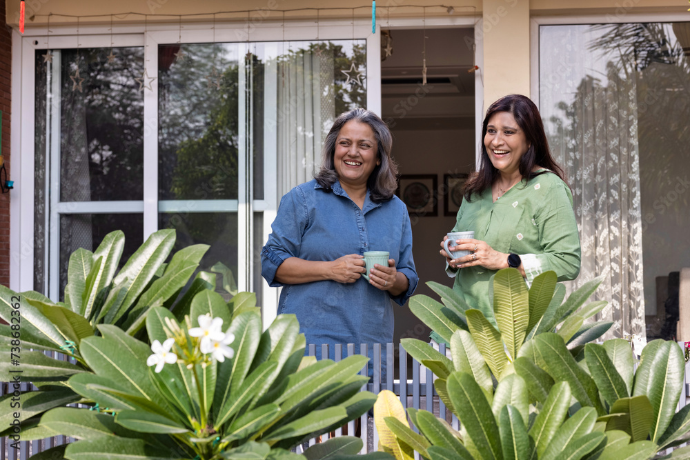 Obraz premium Portrait of happy mother and daughter in the back yard