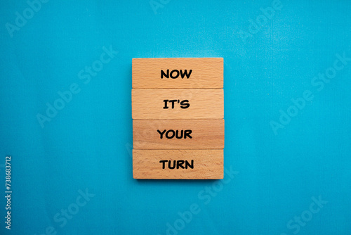 Now it's your turn words written on wooden blocks with blue background. Conceptual business symbol. Copy space.
