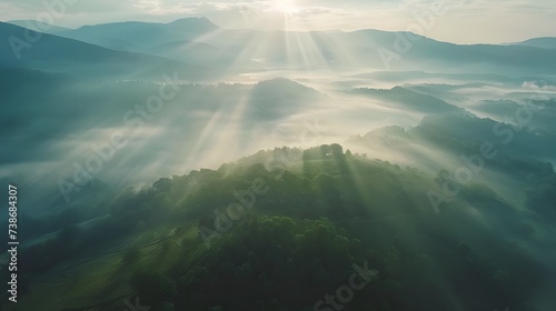 Beautiful aerial View of hilly landscape in morning mist with sun rays  banner format 