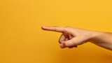 A hand pointing at something on a vibrant yellow background, with ample space for adding text or captions.