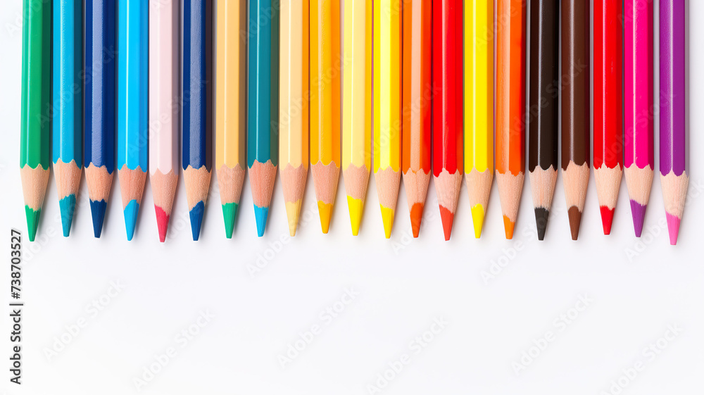 Isolated on a white background, colored pencils are placed on a school notebook. Isolated on a white background, colored pencils are placed on a school notebook.