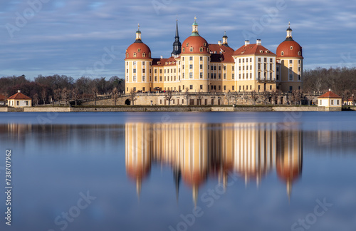 Moritzburg - a fairytale castle reflected on the lake on a sunny day