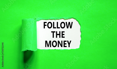 Follow the money symbol. Concept words Follow the money on beautiful white paper. Beautiful green paper background. Business and follow the money concept. Copy space.