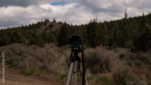 camera on tripod in high desert brush landscape