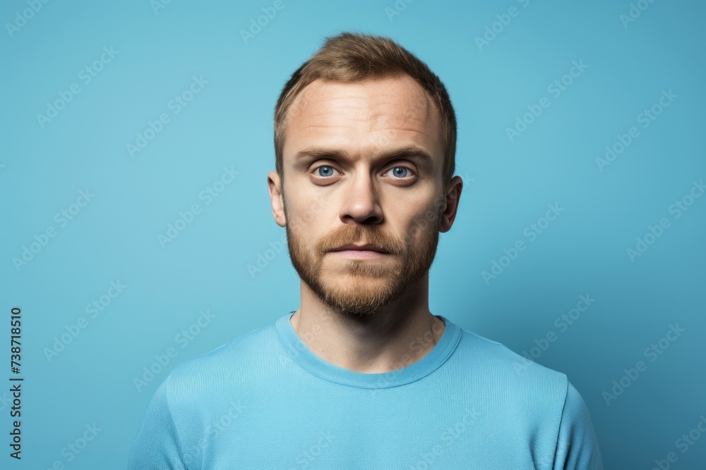 Portrait of a handsome young man with beard on blue background. Portrait of a handsome young man with beard on blue background.
