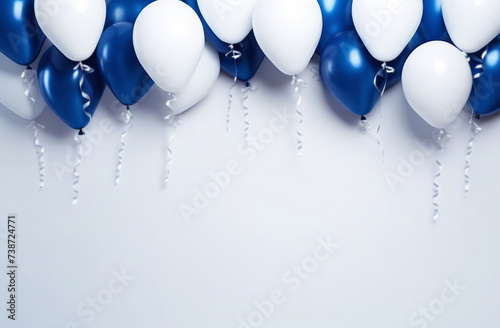 White and dark blue shiny balloons with copy space on light gray plain background. Festive backdrop. Balloons bunch. Horizontal banner. Birthday party decoration. Front view. Space for greeting text.