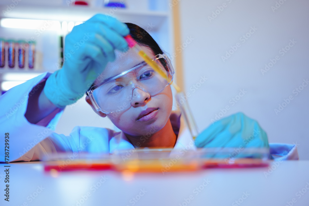 Asian female scientist passionately conducts experiments in a laboratory, surrounded by petri dishes and beakers. Delve into the chemistry of gasoline, food ingredients, and perfumes Asian female scientist passionately conducts experiments in a laboratory, surrounded by petri dishes and beakers. Delve into the chemistry of gasoline, food ingredients, and perfumes