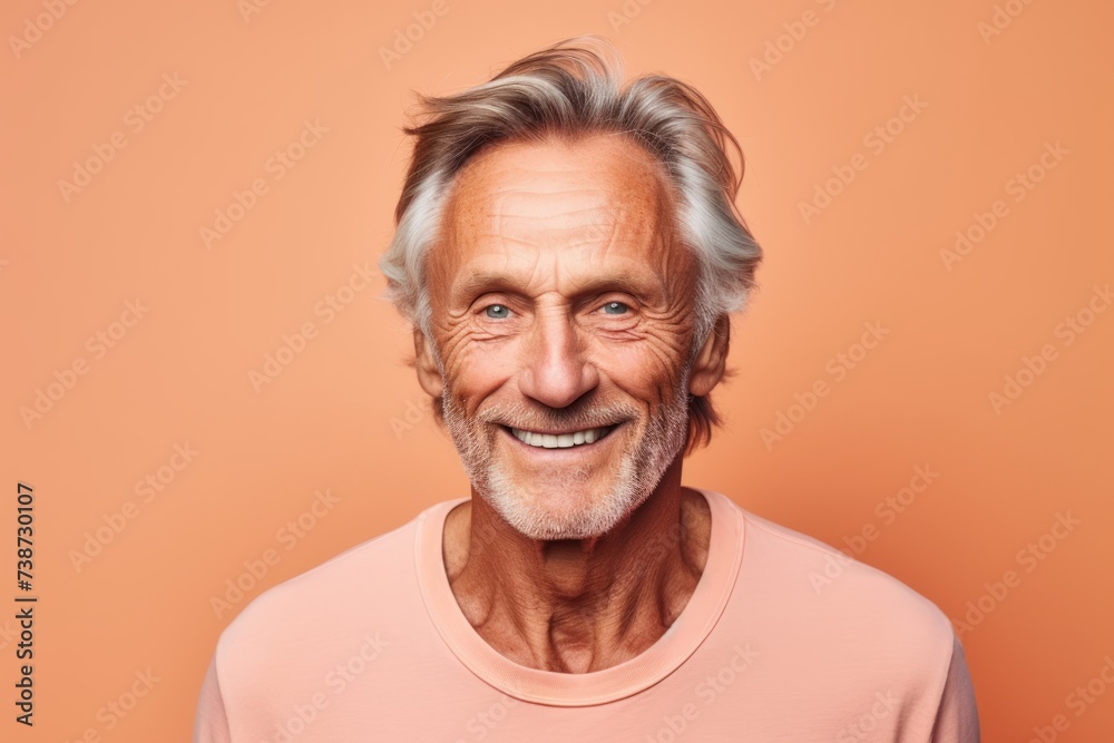 Portrait of a smiling senior man with grey hair, isolated on orange background Portrait of a smiling senior man with grey hair, isolated on orange background