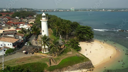Galle Dutch Fort with colonial architecture and lighthouse by the coast of the ocean aerial view