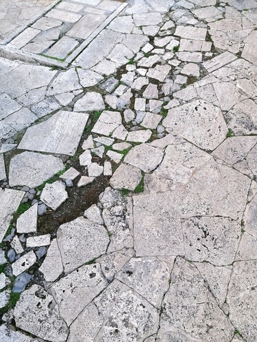 Detail of a floor made of pieces of Roman travertine, damaged by time.