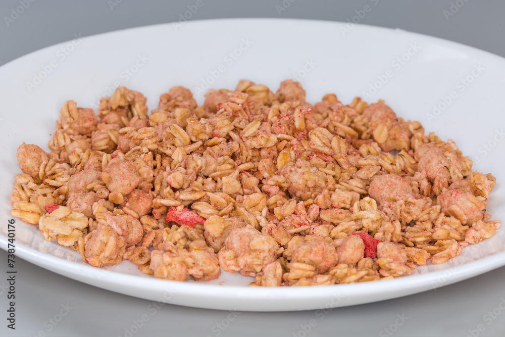 Dry muesli with dried fruits on dish, side view Dry muesli with dried fruits on dish, side view