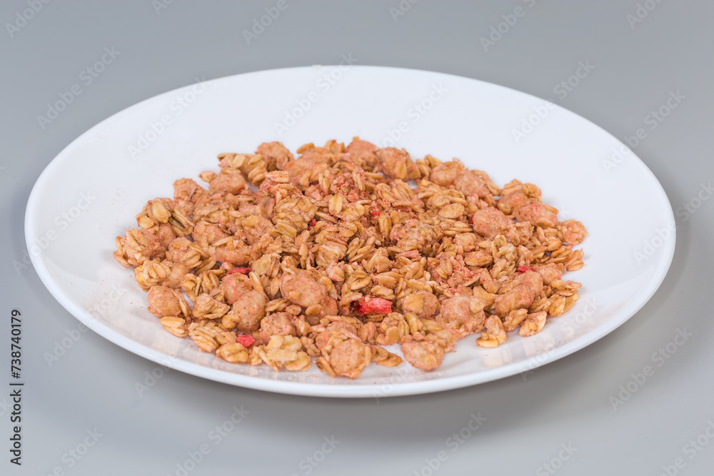Dry muesli with dried fruits on dish, side view Dry muesli with dried fruits on dish, side view