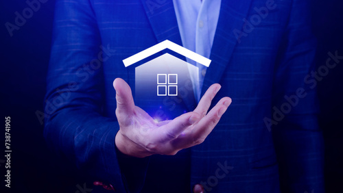 Real estate concept, Businessman holding home icon, Property insurance and security concept, Protecting gesture and symbol house. Real estate agent providing home.