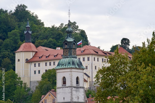 Old town with historic houses and castle on a hill at Slovenian City of Skofja Loka on a cloudy summer day. Photo taken August 9th, 2023, Skofja Loka, Slovenia.