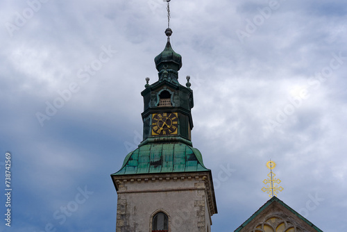 Scenic view of church tower at Slovenian City of Skofja Loka on a cloudy summer day. Photo taken August 9th, 2023, Škofja Loka, Slovenia. photo