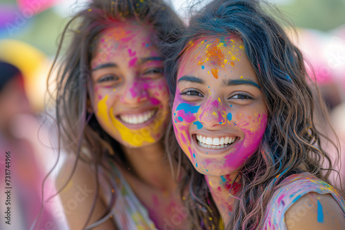 Holi festival or festival of colours. Happy friends with faces smeared in Holi colors, laughing and enjoying the vibrant, festive atmosphere together.