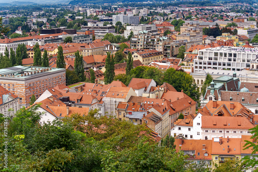 Aerial view of Slovenian City of Ljubljana seen from viewpoint of castle hill on a cloudy summer day. Photo taken August 9th, 2023, Ljubljana, Slovenia.