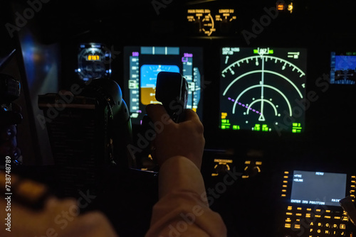 Man holds aircraft helm located near navigation system. Professional captain grasps control yoke in capable hands during flight