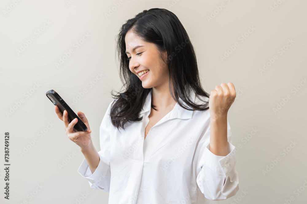 Happy asian young woman using mobile smart phone, read good news online feel excited getting offer, great positive surprise, celebrate success on smartphone. Businesswoman isolated on white background Happy asian young woman using mobile smart phone, read good news online feel excited getting offer, great positive surprise, celebrate success on smartphone. Businesswoman isolated on white background