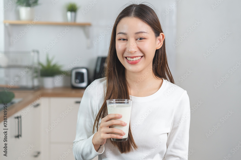 Health care, pretty asian young woman, girl drinking a glass of white fresh, dairy milk for calcium, vitamin wholesome good nutrition in morning at kitchen home. lifestyle, product healthy people. Health care, pretty asian young woman, girl drinking a glass of white fresh, dairy milk for calcium, vitamin wholesome good nutrition in morning at kitchen home. lifestyle, product healthy people.