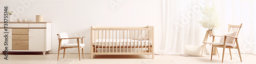 Minimalist nursery with wooden crib, dresser and chair in white and neutral colors. photo