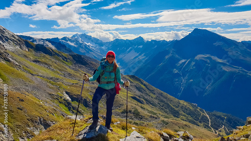 Hiker woman on alpine meadow with panoramic view of majestic mount Hochalmspitze in High Tauern National Park, Carinthia, Austria. Idyllic hiking trail in Austrian Alps. Wanderlust paradise Mallnitz