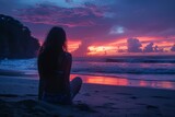 As the clouds drift across the sky, a woman sits peacefully on the sandy shore, her clothing illuminated by the warm afterglow of the sunset as she takes in the beauty of nature and the tranquil ocea