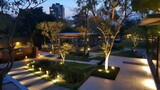 Panoramic Photo of LED Light Posts Illuminated Backyard Garden During Night Hours. Modern Backyard Outdoor Lighting Systems