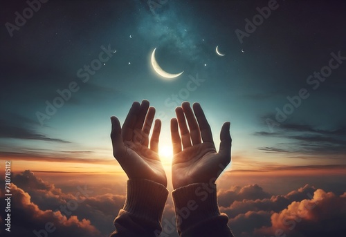 hands raised in prayer towards the sky photo