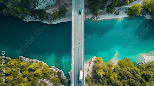 Aerial view of the bridge and the road over River over green island in the middle of the river.