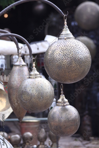 A collection of Moroccan Lamps and Lanterns suspended from a thin wire