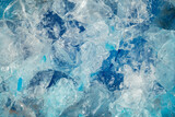 Blue ice surface with cracks background texture. close-up frozen water. broken ice.