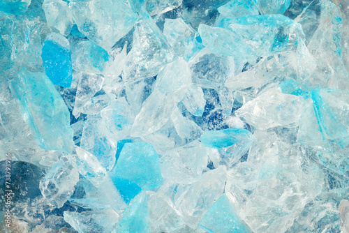 broken ice close up. pieces of crushed blue ice cracks background texture. close-up frozen water.