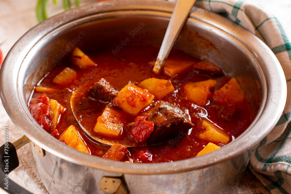 Goulash with potatoes and vegetables seasoned with paprika and other spices. Perfect for recipe, menu book, or any cooking contents. Typical Czech food. Hungarian cuisine. Goulash with potatoes and vegetables seasoned with paprika and other spices. Perfect for recipe, menu book, or any cooking contents. Typical Czech food. Hungarian cuisine.