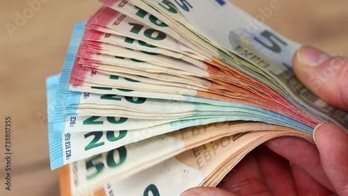 Euro money, stacks of euro banknotes in hands, common currency of euro zone in european union, financial concept, close up photo