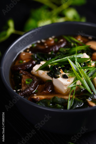 Japanese food. Miso soup. on a black wooden background.