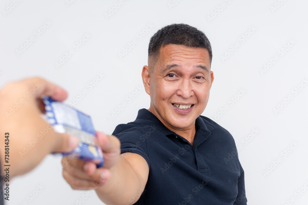 A happy and thankful middle aged man receives a packet of crackers. Having a quick snack, posing on a white background. A happy and thankful middle aged man receives a packet of crackers. Having a quick snack, posing on a white background.