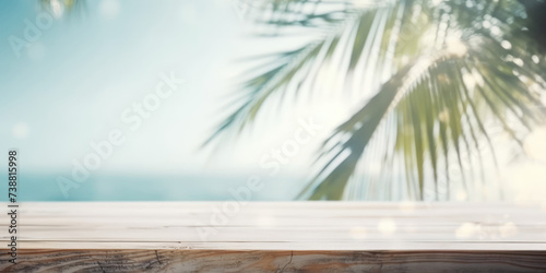 Wooden table top in the foreground on a blurred background with summer sea beach and tropical palm trees leaves. Mockup table for product display, copy space