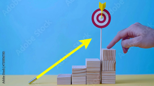 A conceptual image depicting success, with a finger pointing to a bullseye on a target that's placed atop a stair-like arrangement of wooden blocks. AI generated.