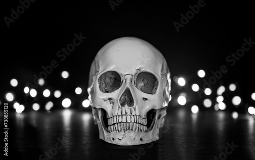 skull on black with bokeh light background