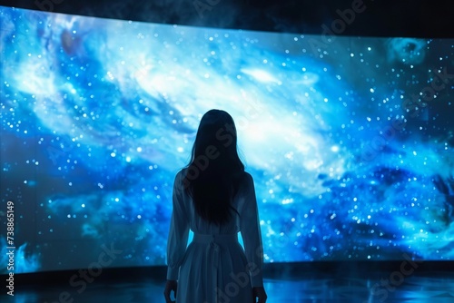 Woman in Front of Large Screen with Space for Text or Graphics