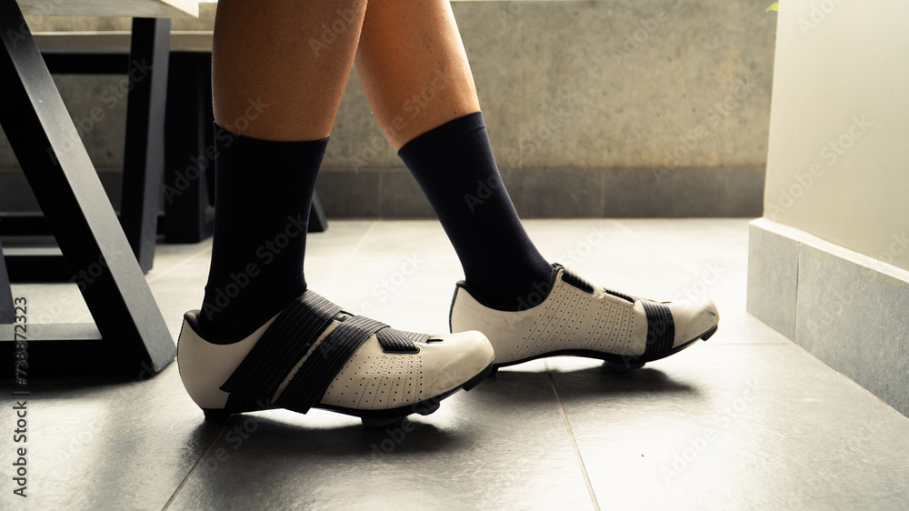 Male wearing his cycling shoes and preparing to go out for training in the mountains of Medellin, Colombia Male wearing his cycling shoes and preparing to go out for training in the mountains of Medellin, Colombia
