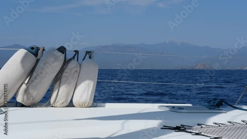 smooth sailing movenet of sail catamaran, sea landscape, white deck, waves, sunny summer holiday vacation day photo