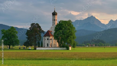 Drone wiew of the Saint Coloman church near the Neuschwanstein castle, against the backdrop of the beautiful mountains, Schwangau in the Bavarian province of Germany